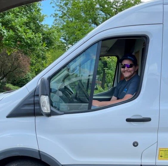 Plumber in plumbing van